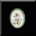 J099. Oval pin painted with daffodil. - $14 